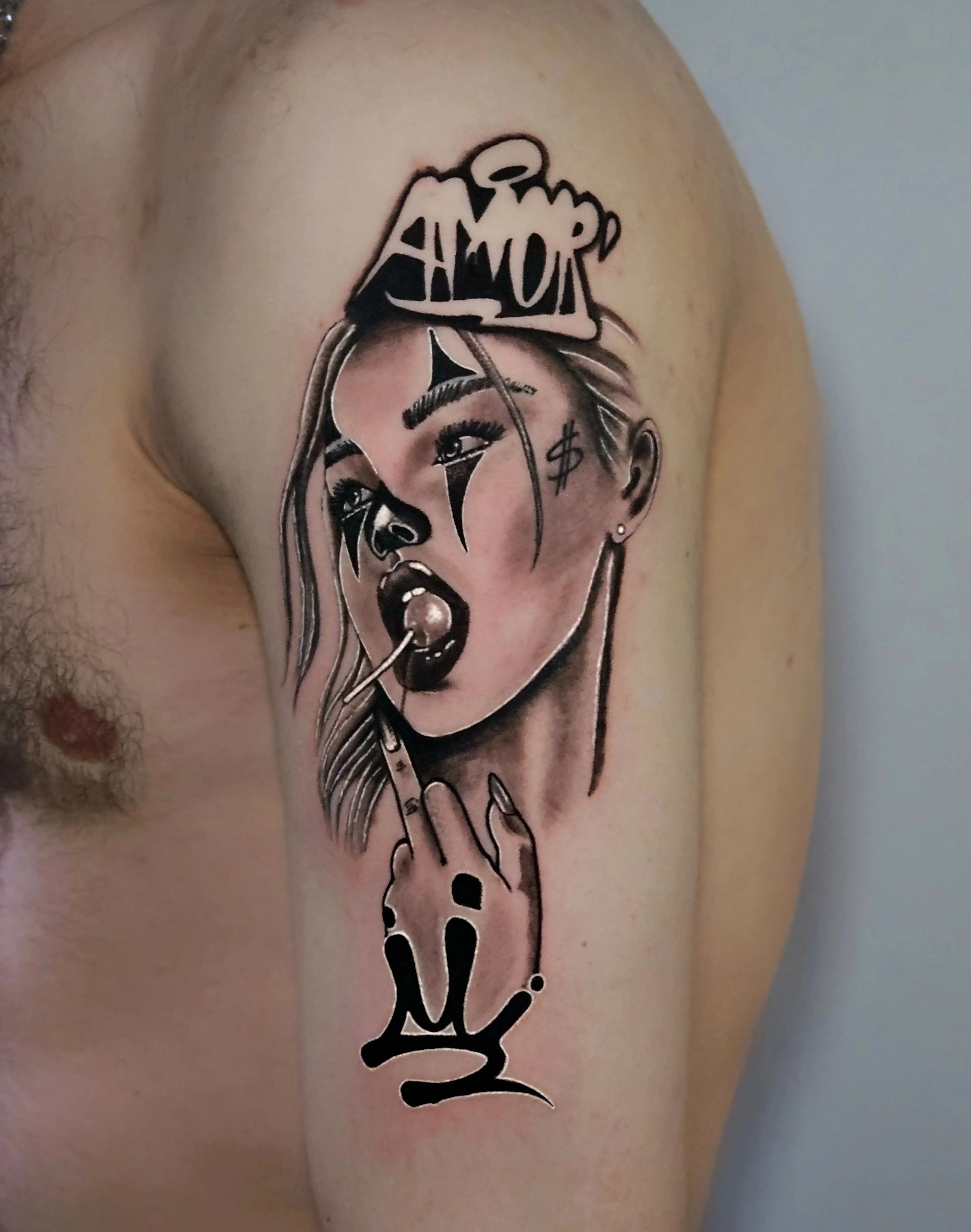 Black and gray portrait tattoo of a woman with graffiti text 'AMOR' and crown symbol.